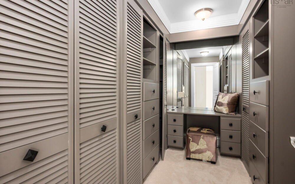 Walk in closet featuring light carpet