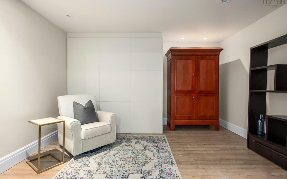 Living area featuring baseboards, light wood-type flooring, and recessed lighting