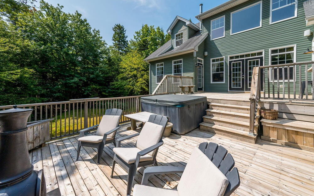 Wooden deck featuring a hot tub