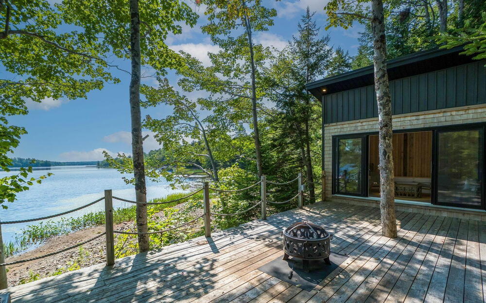 Wooden deck with a water view and a fire pit