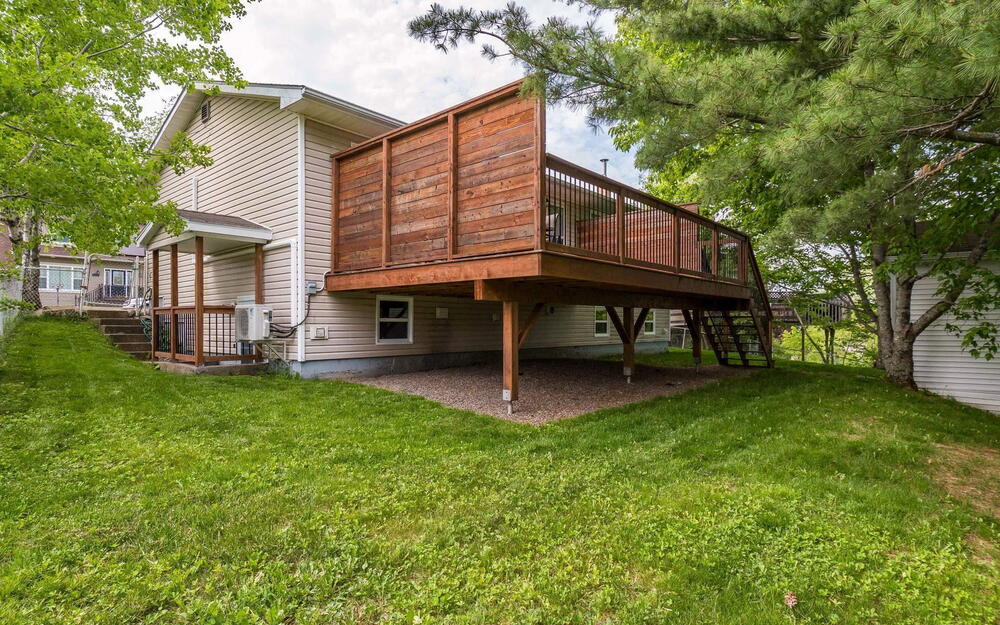 Elevated wood deck with privacy wall and metal balusters